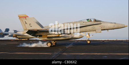 An F/A-18 Hornet assigned to VMFA-312 lands aboard USS Harry S. Truman after a mission over Afghanistan. Stock Photo