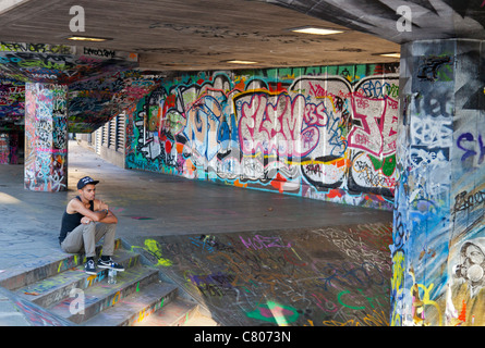 Grafitti-land on the South Bank, London-resting cyclist Stock Photo