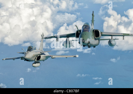 A Dassault Rafale of the French Air Force flys alongside an Embraer A-1B of the Brazilian Air Force. Stock Photo