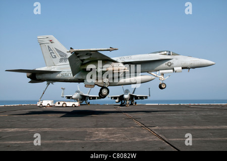 A US Navy F/A-18E Super Hornet prepares to land aboard USS Eisenhower. Stock Photo