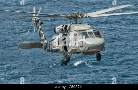 A US Navy SH-60F Seahawk flying off the coast of Pakistan. Stock Photo