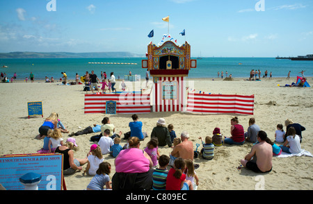 Punch and Judy show on Weymouth beach, Dorset. Stock Photo