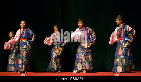 TIBETAN DANCERS at the TIBETAN MONGOLIAN CULTURAL CENTER during a teaching by the 14th DALAI LAMA - BLOOMINGTON, INDIANA Stock Photo