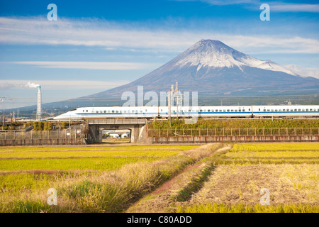 Bullet Train passing by Rice Field and Mount Fuji Stock Photo