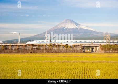 Bullet Train passing by Rice Field and Mount Fuji Stock Photo