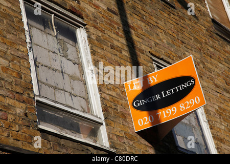 Derelict houses with To Let sign in London, UK Stock Photo