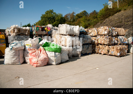 Bales of compacted waste awaiting collection at a recycling centre yard ...