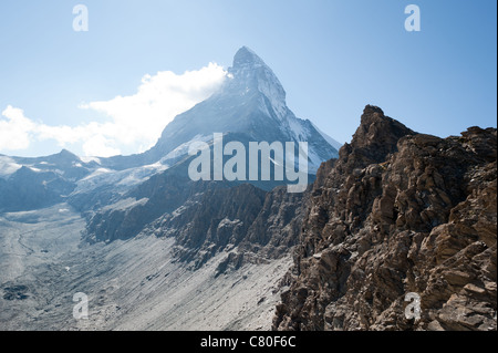 The Matterhorn towers amongst clouds in the Swiss Alps as photographed on a trek to basecamp Hornlihutte. Stock Photo