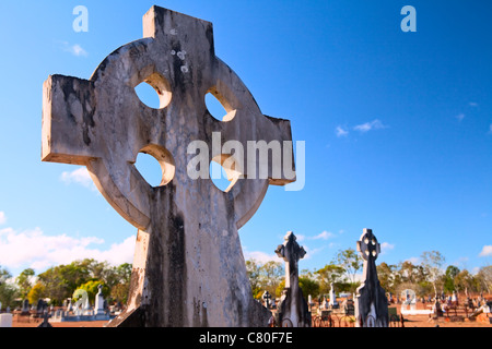 celtic cross on australian graveyard old ancient burial ground cemetery tombstone with copy space in blue sky Stock Photo