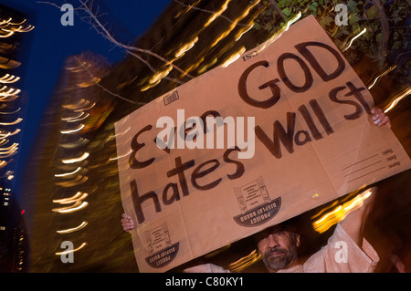 Anti Wall Street Protester in Zuccotti Park holds a sign Even God Hates Wall Street Stock Photo