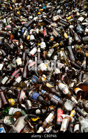 Piles of brown glass bottles at a recycling yard UK Stock Photo