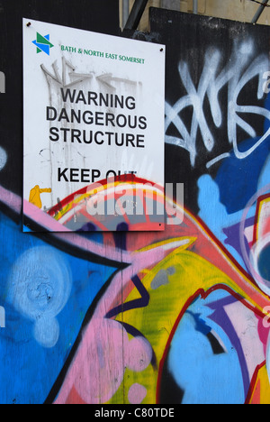 graffiti covered warning at building site Bath UK Stock Photo