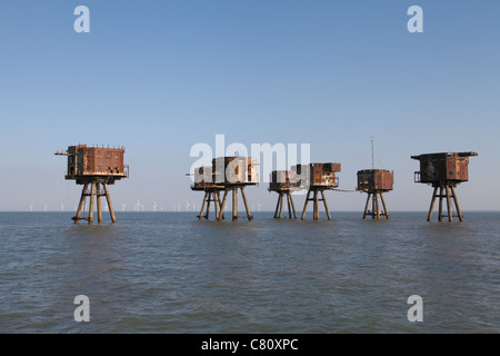 The abandoned wartime Redsands fort in the Thames estuary. The Kentish flats windfarm can be seen beyond on the horizon. Stock Photo