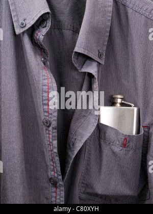 Conceptual view of alcoholism presented with a hip flask in a shirt pocket. Stock Photo