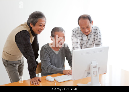 Senior Three Men at Computer Stock Photo