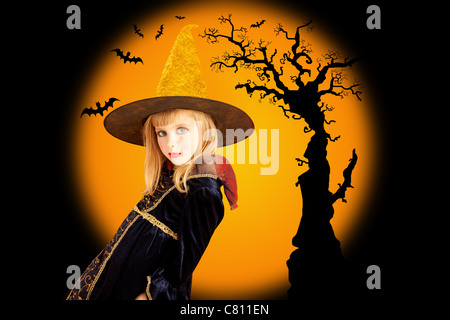 Halloween beautiful girl in dried tree and bat orange background Stock Photo