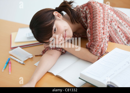 Collage Student Lying on Desk Stock Photo