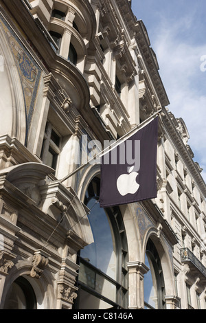 Looking up at the corporate flag of Apple's logo on a banner high above street level at Regent House (1898) in Regent's Street. Stock Photo