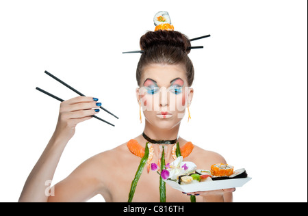 A creative and colorful image of a fashion model wearing asian themed makeup and raw sushi Stock Photo