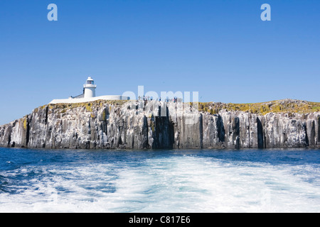Inner Farne Lighthouse and tourists photographing the seabird colony. Farne Islands, Northumberland Coast, England. Stock Photo
