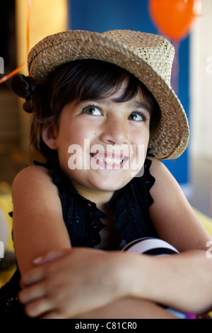 Mixed race girl wearing straw  hat Stock Photo