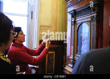 Tourist taking photo of Benois Madonna by Leonardo da Vinci, Hermitage Museum, St. Petersburg, Russia Stock Photo