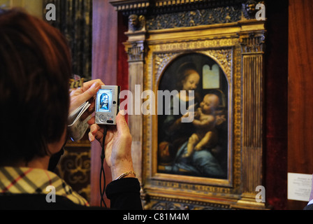 Tourist taking photo of Benois Madonna by Leonardo da Vinci, Hermitage Museum, St. Petersburg, Russia Stock Photo