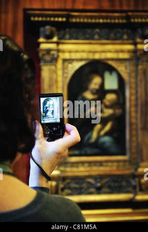 Tourist taking photo of Benois Madonna by Leonardo da Vinci, Hermitage Museum, St. Petersburg, Russia Stock Photo