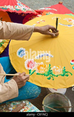 Painting parasols at the umbrella village Bo Sang, Thailand Stock Photo