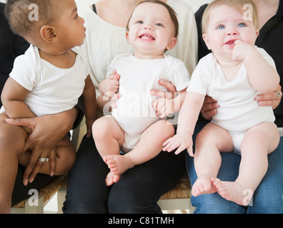 Mothers holding babies on their laps Stock Photo