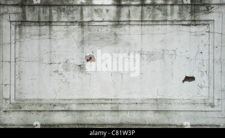 cracked streaked plastered old wall for background texture Stock Photo