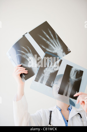 Korean doctor looking at x-rays of hand bones Stock Photo