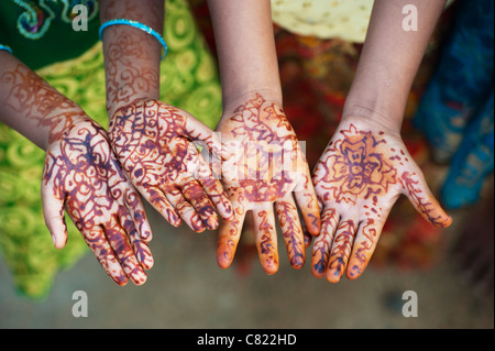 Young Indian girls holding out their henna covered hands. Andhra Pradesh, India Stock Photo