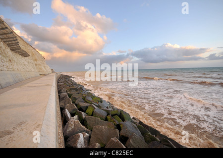 The sea at dramatic sunset, Chalk cliffs and the Undercliff walk, Brighton in East Sussex, UK Stock Photo