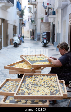 Woman making pasta on the streets of Bari old town, Puglia Italy. Photo:Jeff Gilbert Stock Photo