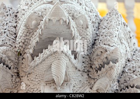 spooky statue of thai mythology buddhist creature in a chiang mai temple courtyard, thailand Stock Photo