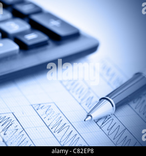 Profit bar chart, pen and calculator. Shallow DOF! Focus on the pen. Stock Photo