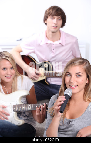 teenagers playing music instruments Stock Photo