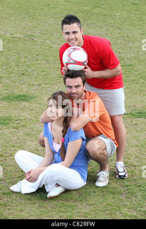 Friends taking a break from playing football Stock Photo