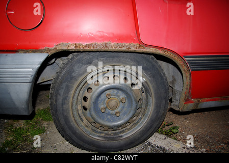 corrosion on a car mudguard, rusty car Stock Photo