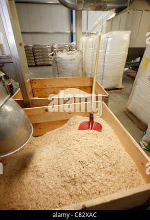 Production of wood pellets. A type of wood fuel. Sawdust is manufactured to pellets. Used in boilers of central heating systems. Stock Photo