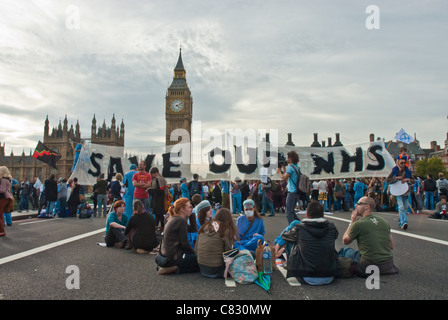 Health workers in theatre scrubs occupy Westminster Bridge to protest the Health and Social Care Bill. Save our NHS, Big Ben Stock Photo