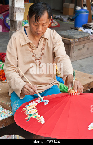 Painting parasols at the umbrella village Bo Sang, Thailand Stock Photo