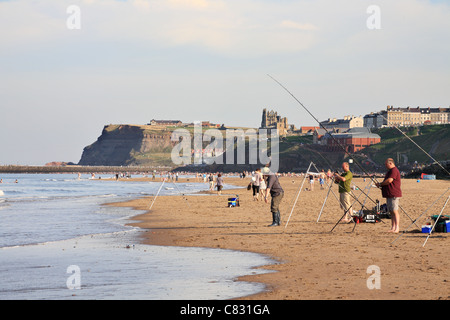 People fishing from beach at Whitby, Yorkshire, England Stock Photo