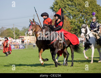 Working horse Group of adults working at a jousting show Ardingly, UK Stock Photo