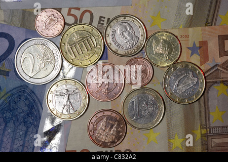 various countries euro banknotes and coins euros from spain italy ireland germany finland cyprus Stock Photo