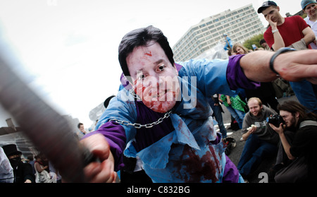 UKuncut's Block the Bridge action, protesting against NHS reform bill. Activist, wearing a Nick Clegg mask 'murders the NHS'. Stock Photo