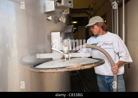 Bryan Babcock prepares stainless steel tanks for the crush, Babcock Vineyard, Santa Rita Hills, California Stock Photo