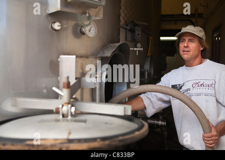 Bryan Babcock prepares stainless steel tanks for the crush, Babcock Vineyard, Santa Rita Hills, California Stock Photo