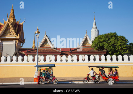 Cambodia, Phnom Penh, Tuk Tuk and Mobile Soft Drink Vendor in front of the Royal Palace Stock Photo